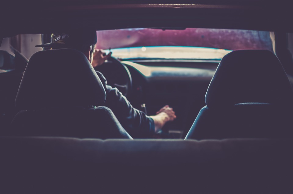 man wearing hat driving